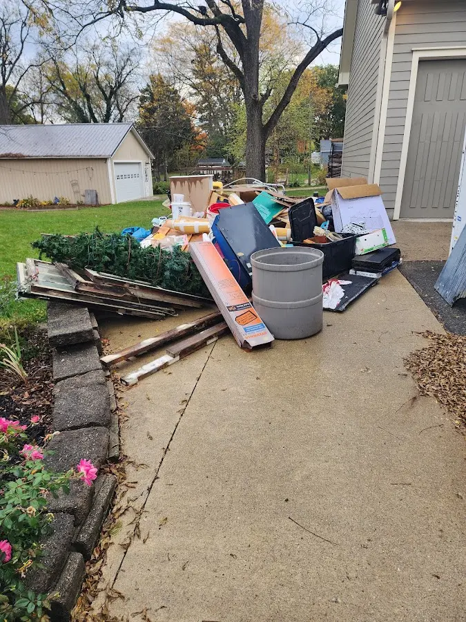 Dumpster being loaded with debris for Estate Cleanout Dumpster Rental in Hurricane